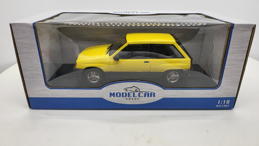 MCG: Opel Corsa A SR Geel (1982) - Schaal 1:18