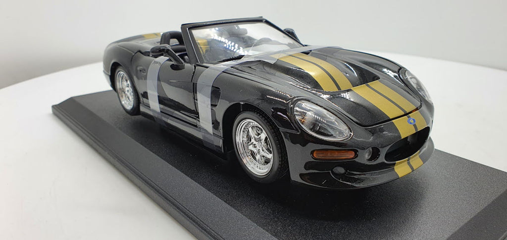 Maisto: Shelby Series 1 Zwart/Goud - Schaal 1:18
