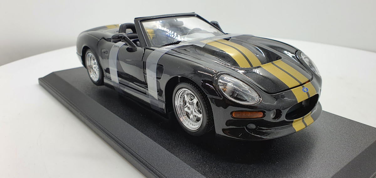 Maisto: Shelby Series 1 Zwart/Goud - Schaal 1:18